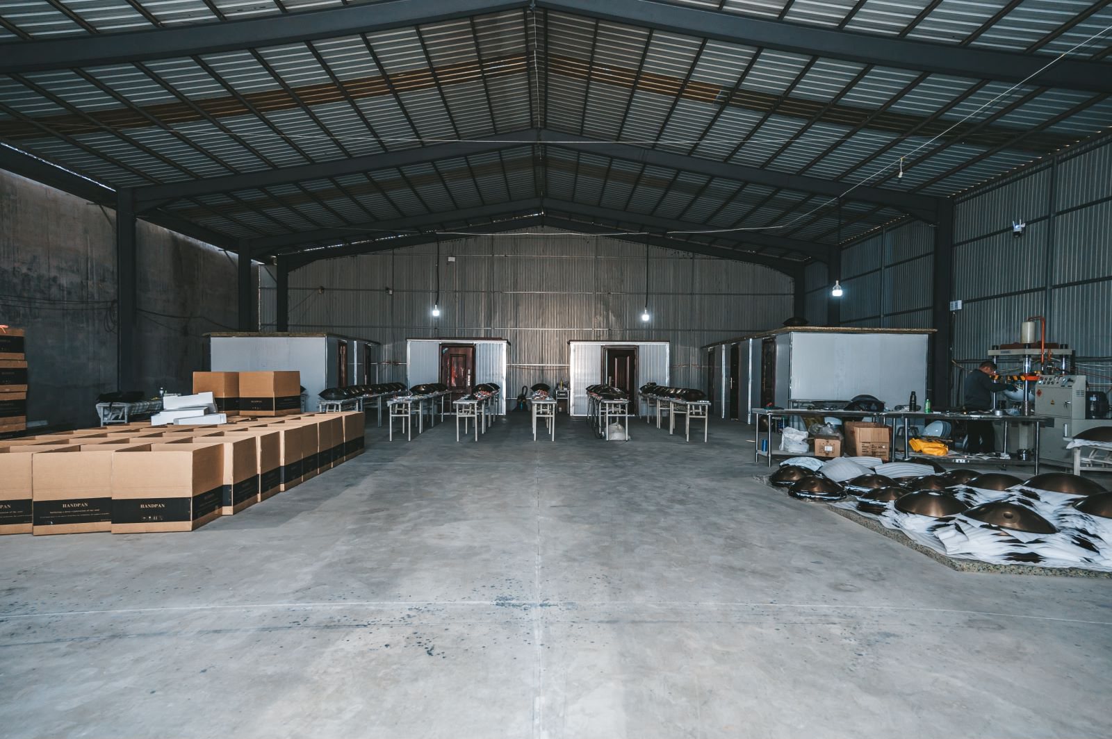 Finished handpans and export cartons in the Linyi workshop